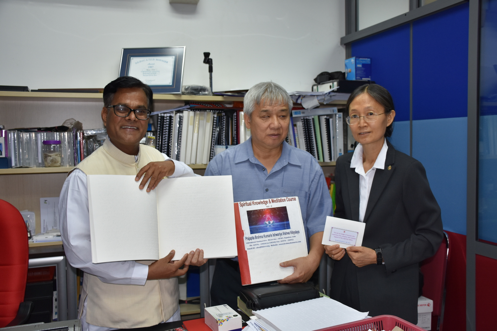 Presentating the braille book to the executive director. National council for the blind. Malaysia